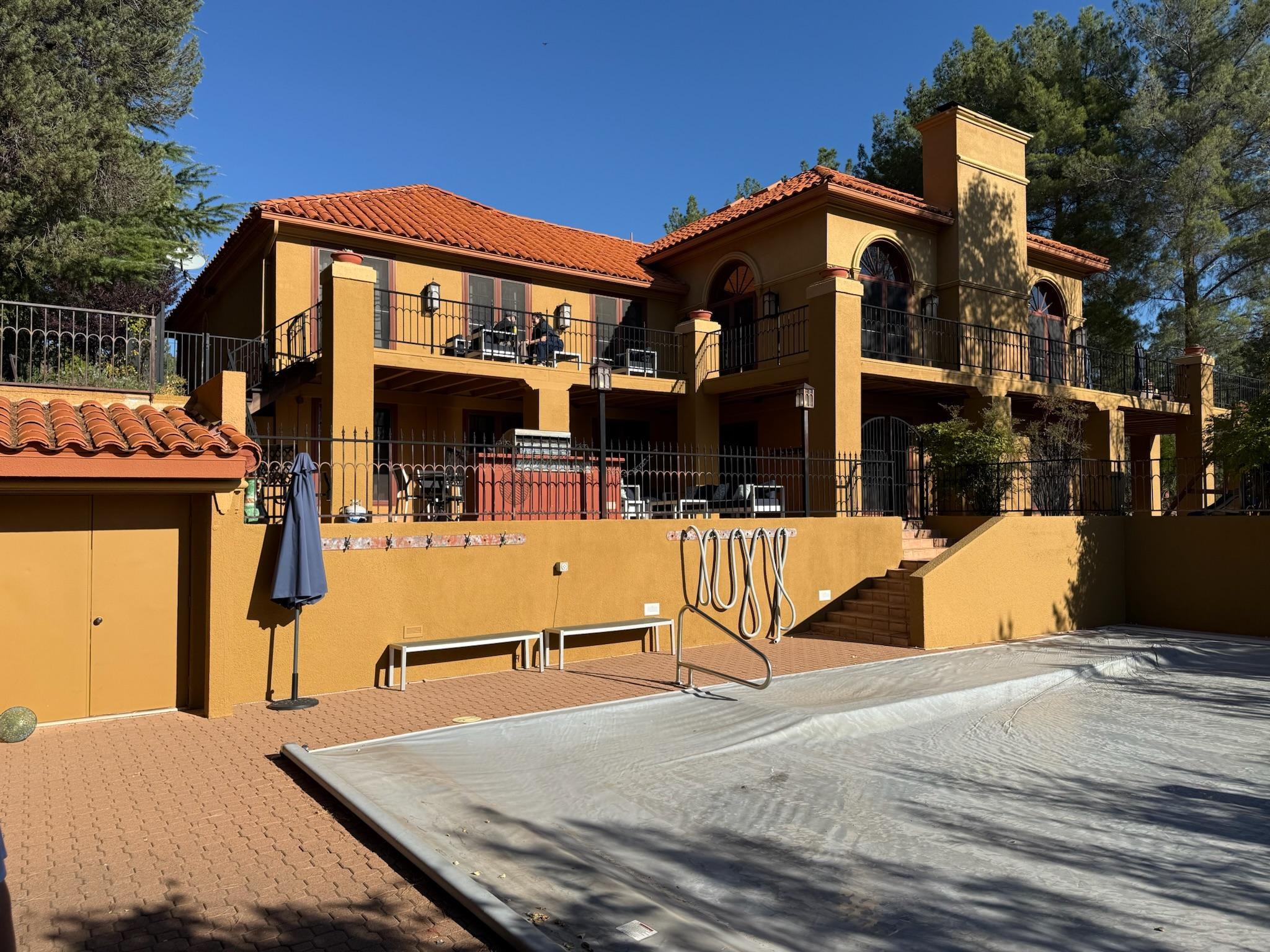 Rear of home with pool covered.