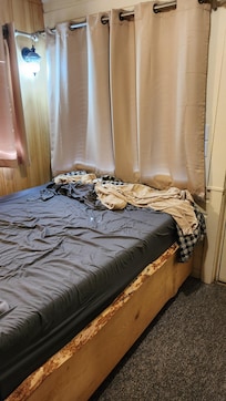 Bed by front door.