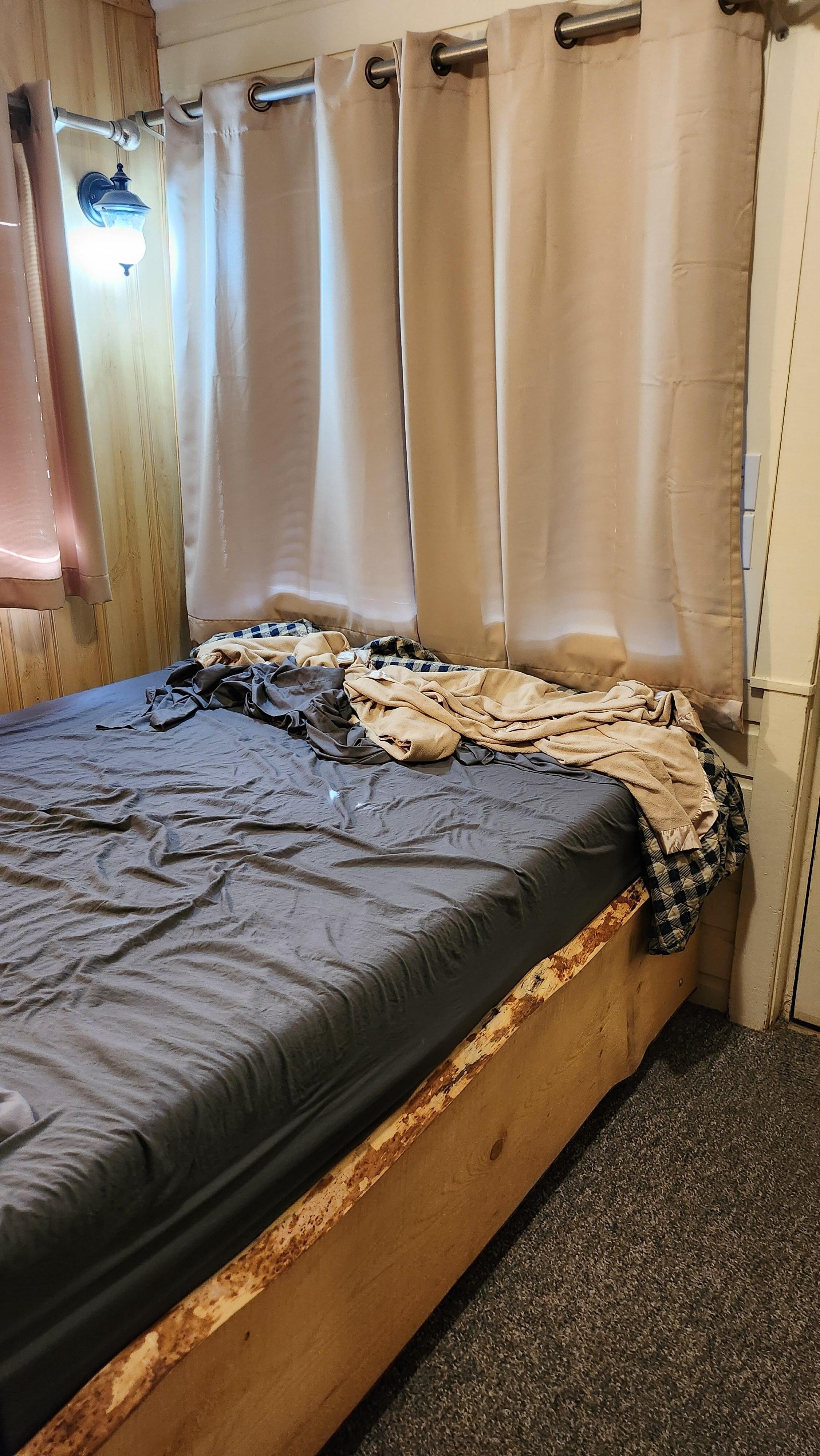 Bed by front door.