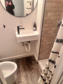 Small shower and sink. Everything you need. Nothing you don’t.