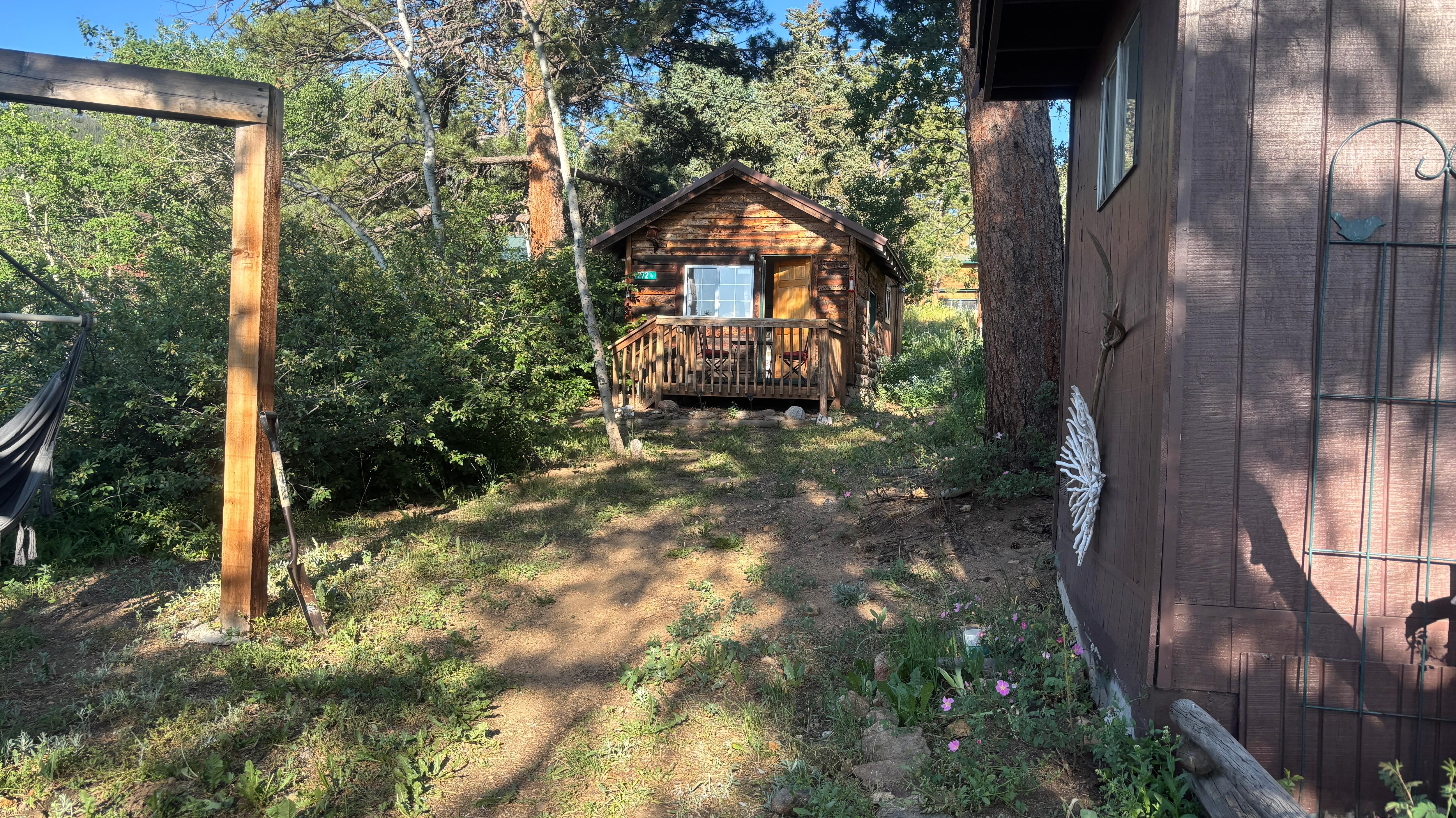 Cabin is behind another cabin on a small piece of property in town. 