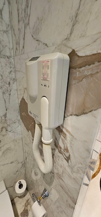 Since there are no outlets in the bathroom, you get this hairdryer.