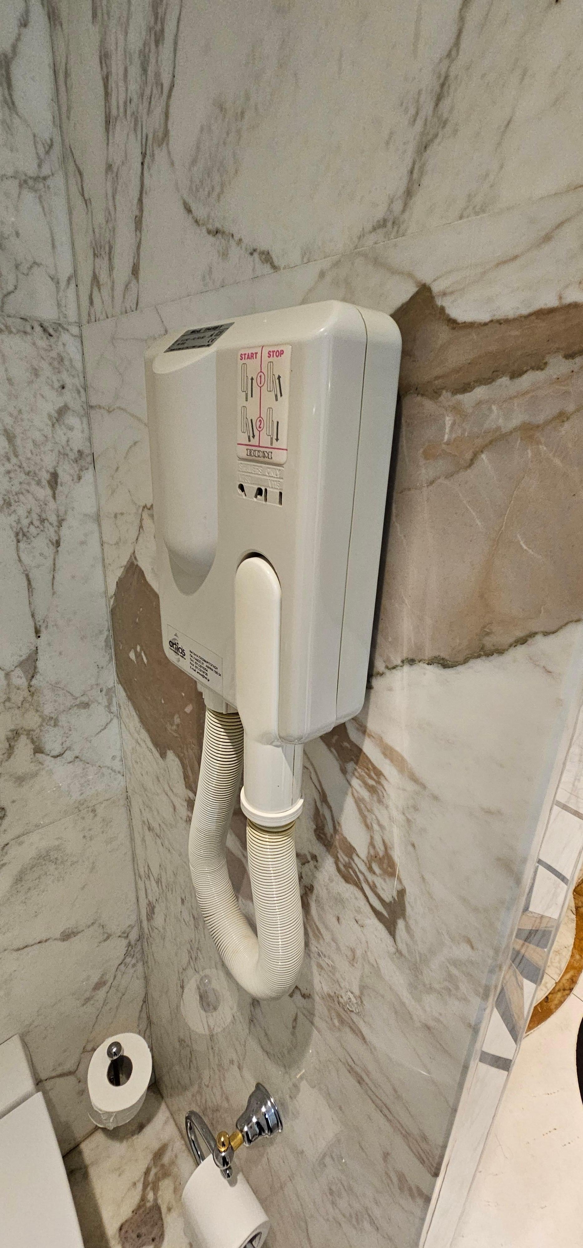 Since there are no outlets in the bathroom, you get this hairdryer.