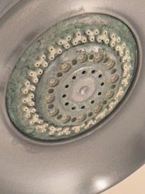 Soap scum build up on the shower head