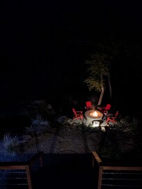 The fire pit at night from the balcony.