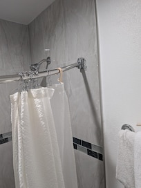 Damaged shower curtain rod left unrepaired.