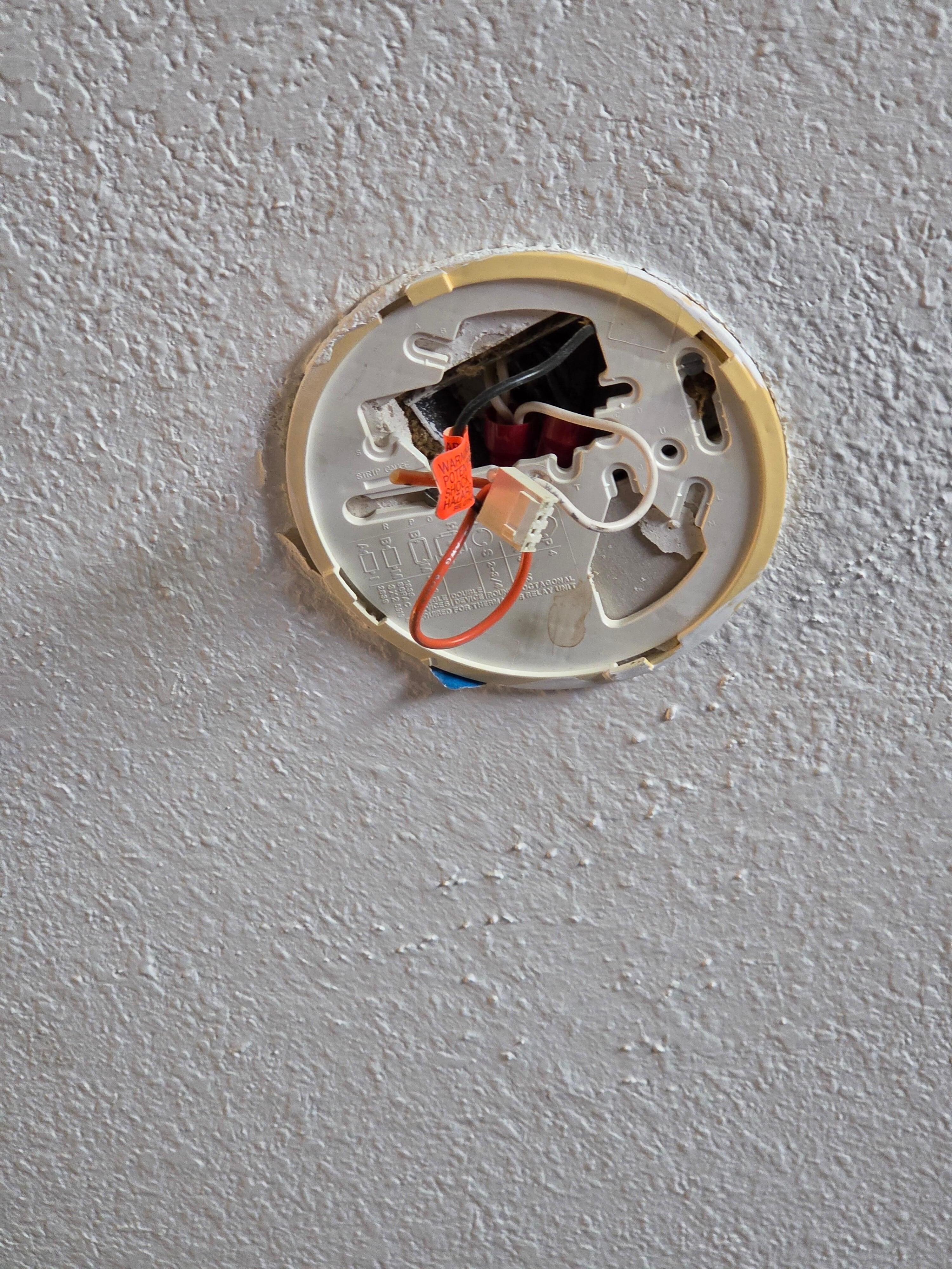 Wires hanging from ceiling smoke alarm