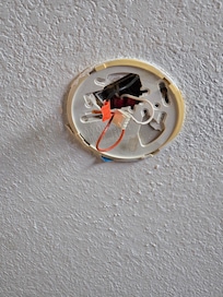 Wires hanging from ceiling smoke alarm