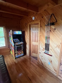 Arcade machine next to pool table