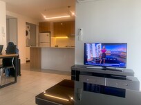 Spacious area with dining table and work desk out of shot