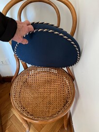 Chair that is breaking at the dining table.