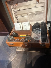 A leather suitcase served as a bar