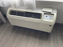 Broken/missing pieces on air conditioner that also emitted urine smell.