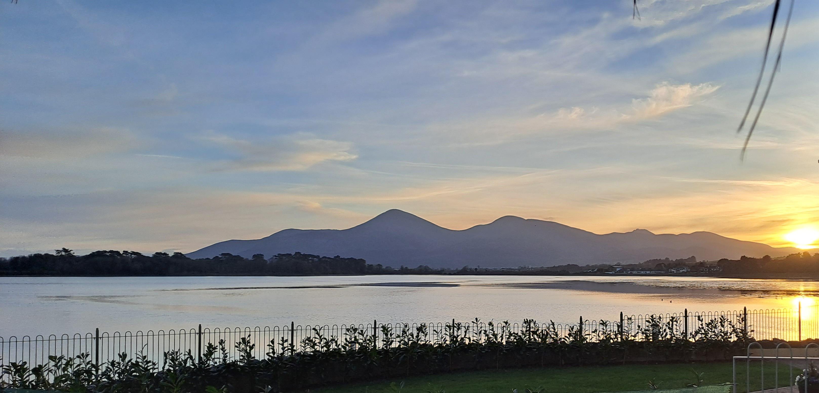 The view from the patio as the sun sets behind the Mourne Mountains.