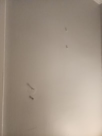 multiple screws and holes in the room where assuming pictures were hung