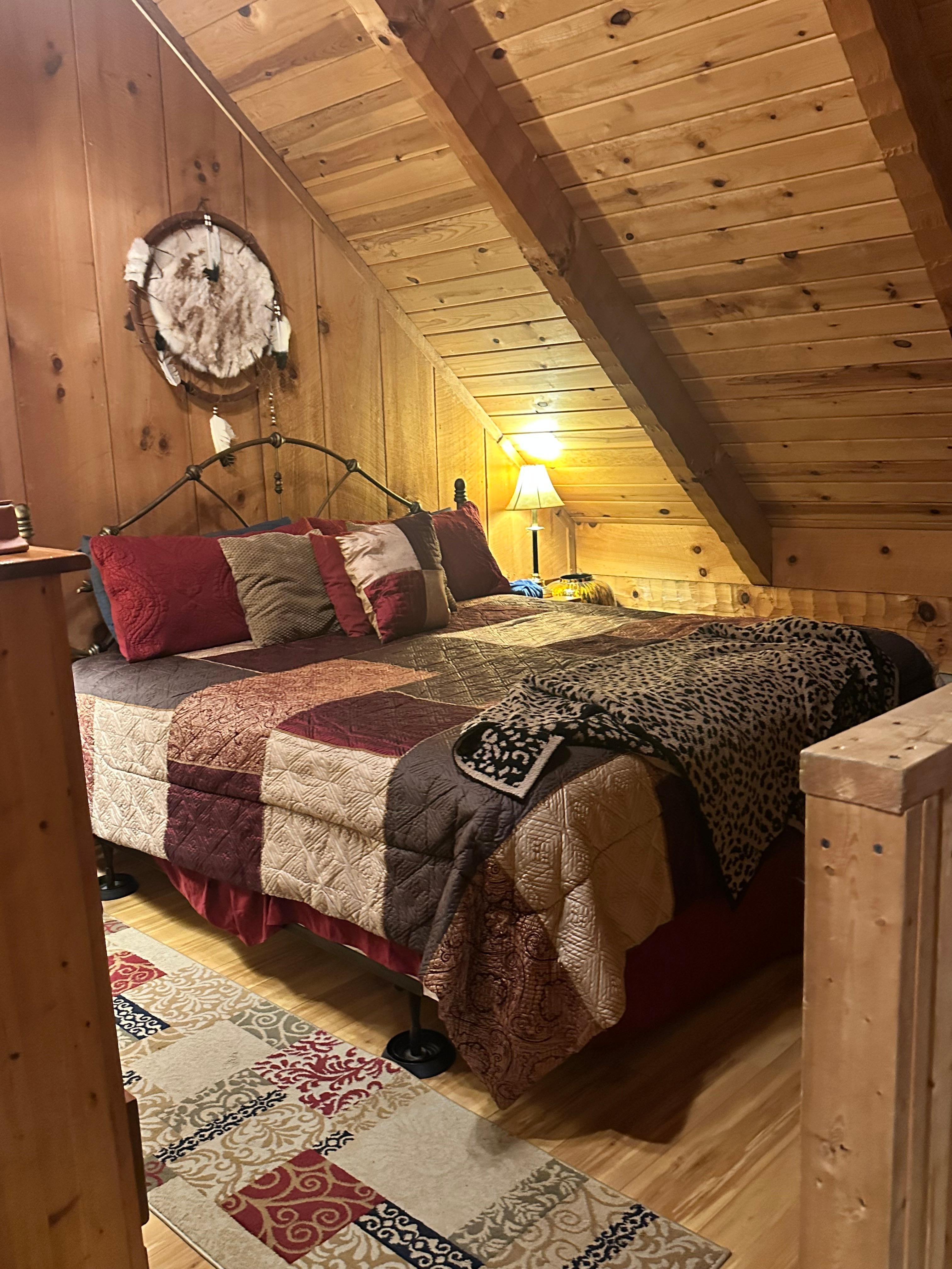 Loft with king bed and the edge of the railing 