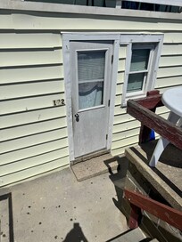 Front door, no key given, broken blind