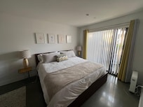 Spacious primary bedroom with a wall of closet space