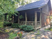 Cabin entrance viewed from driveway/parking area