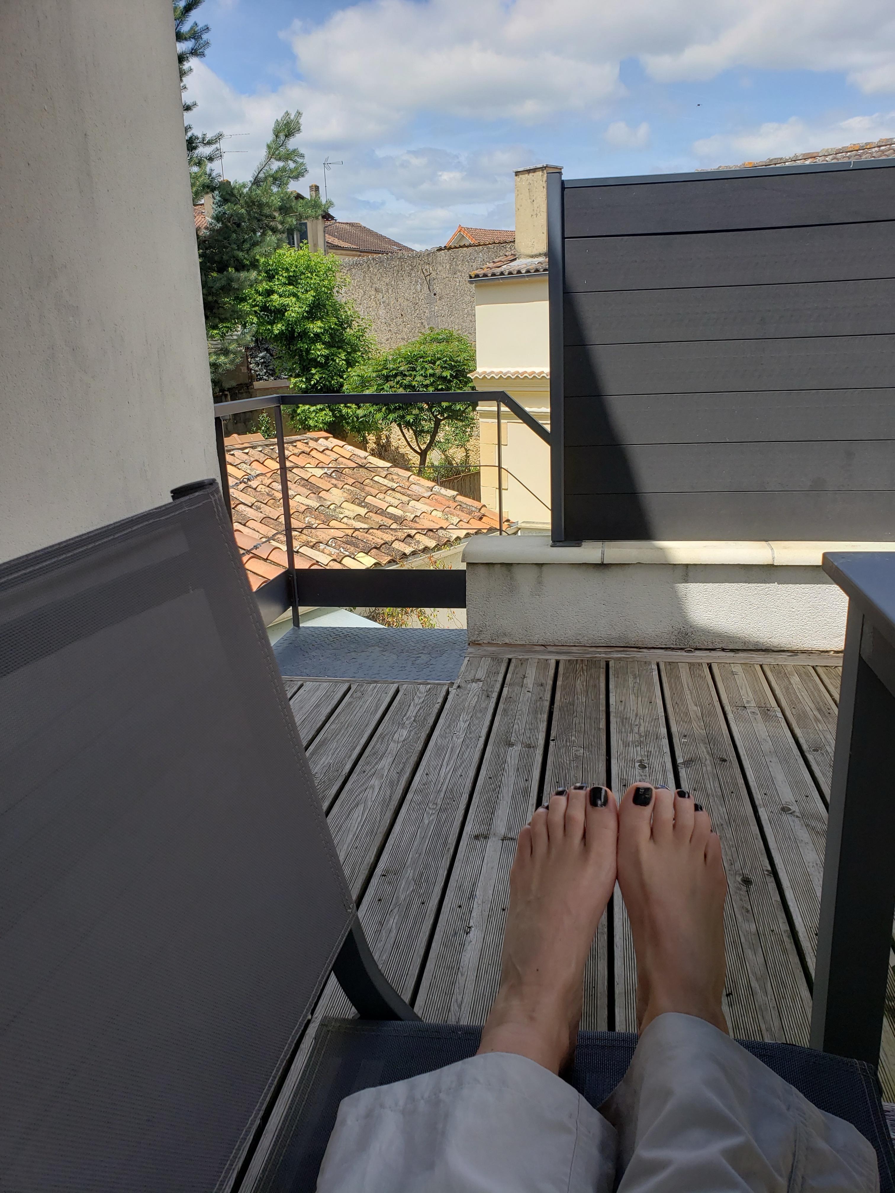View of pretty gardens and rooftops from the deck.