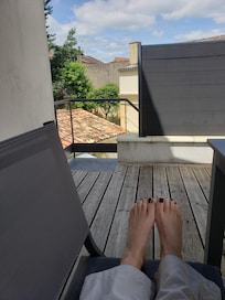 View of pretty gardens and rooftops from the deck.