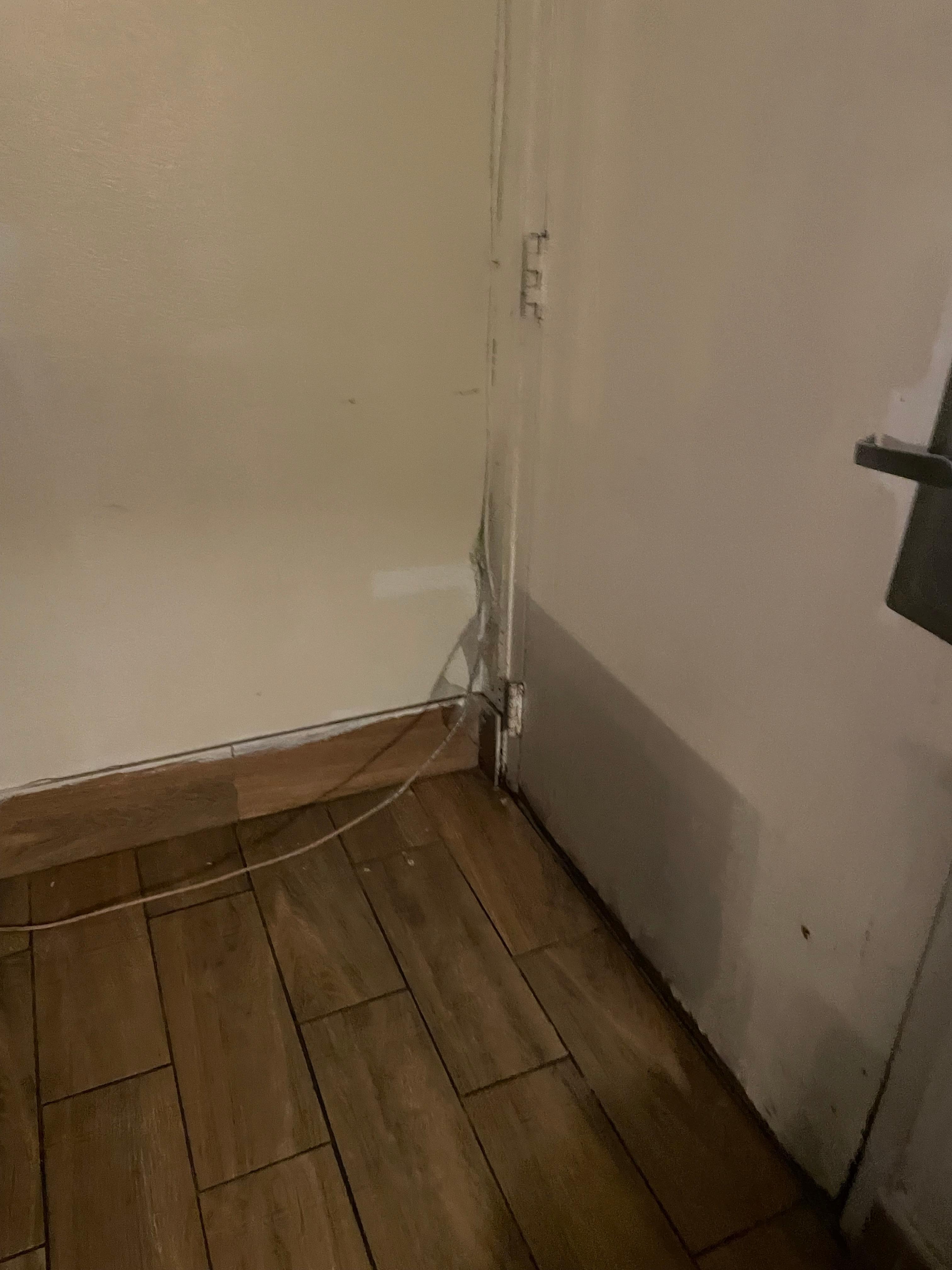 Looks like the door has been kicked in - wires hanging out of everywhere. Every inch of the room need repair/replacement.