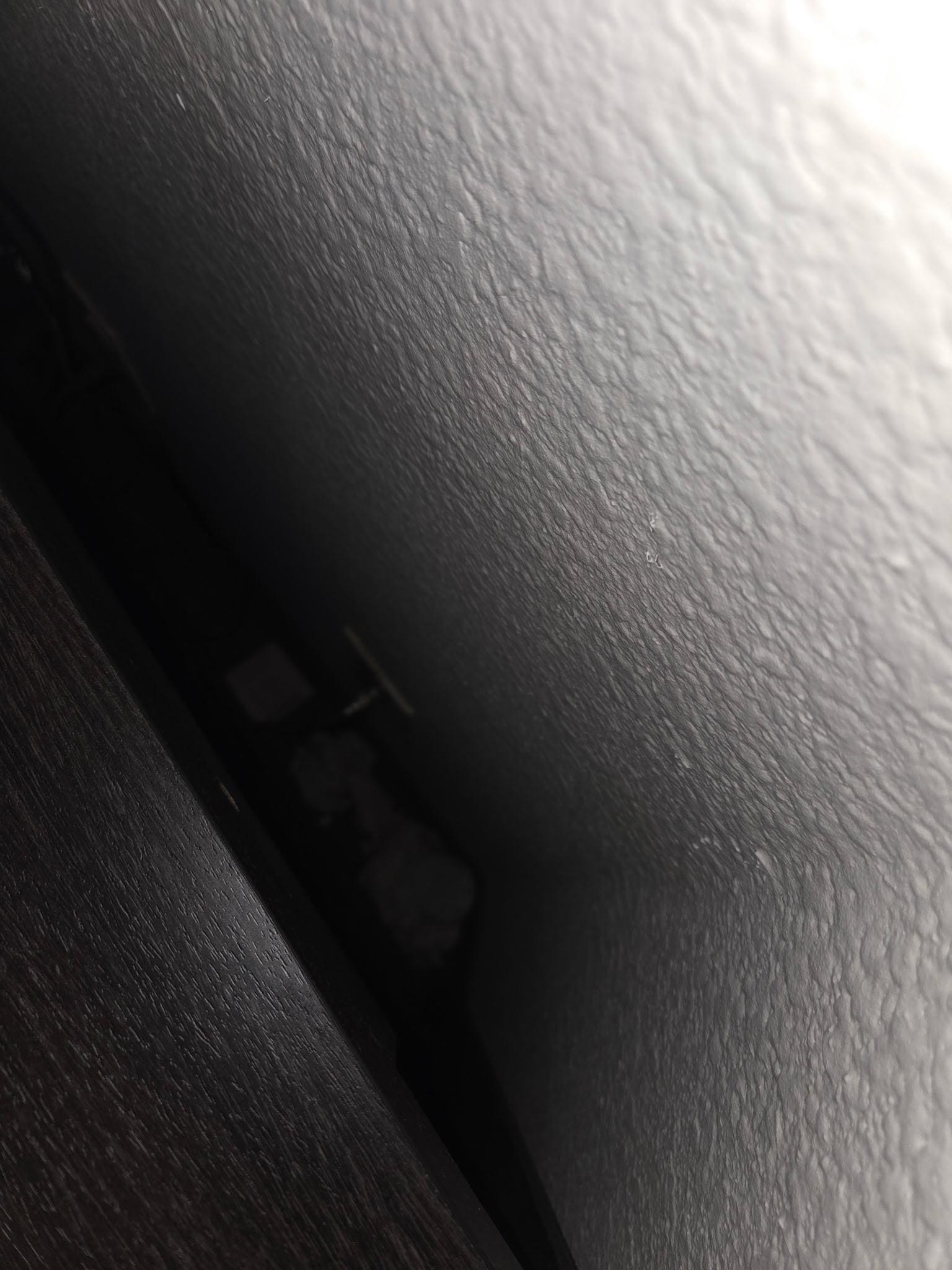 Trash behind tv stand