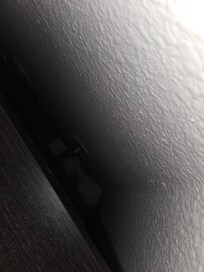 Trash behind tv stand