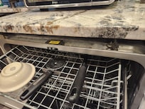 Dishwasher falls out of cabinet when shelves slide out