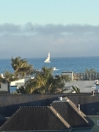 Nightly view from the back balcony. Fog in the back covers Monterey peninsula. Wednesday is sail regatta afternoon.