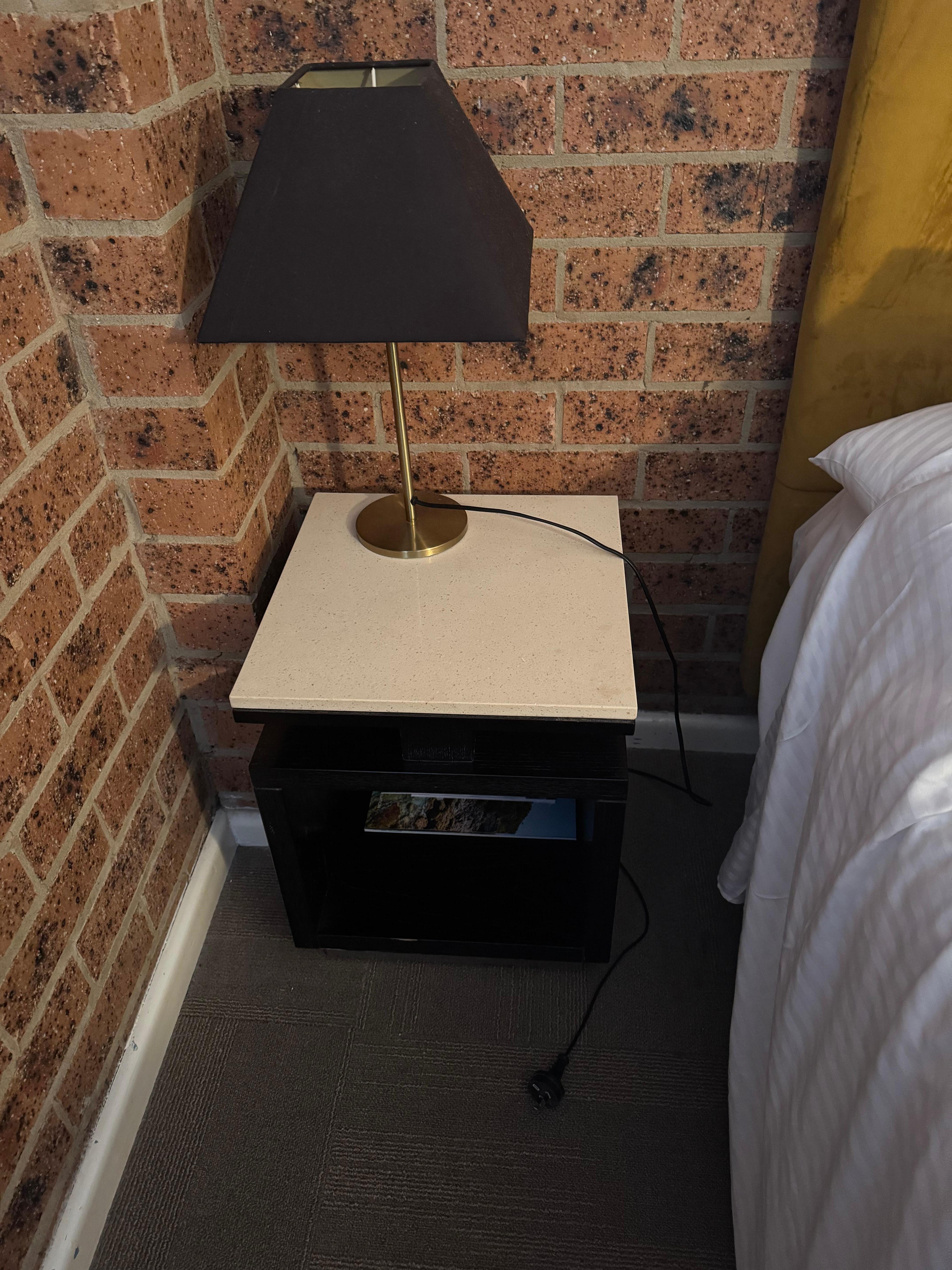 Nowhere to plug in lamp or phone beside bed