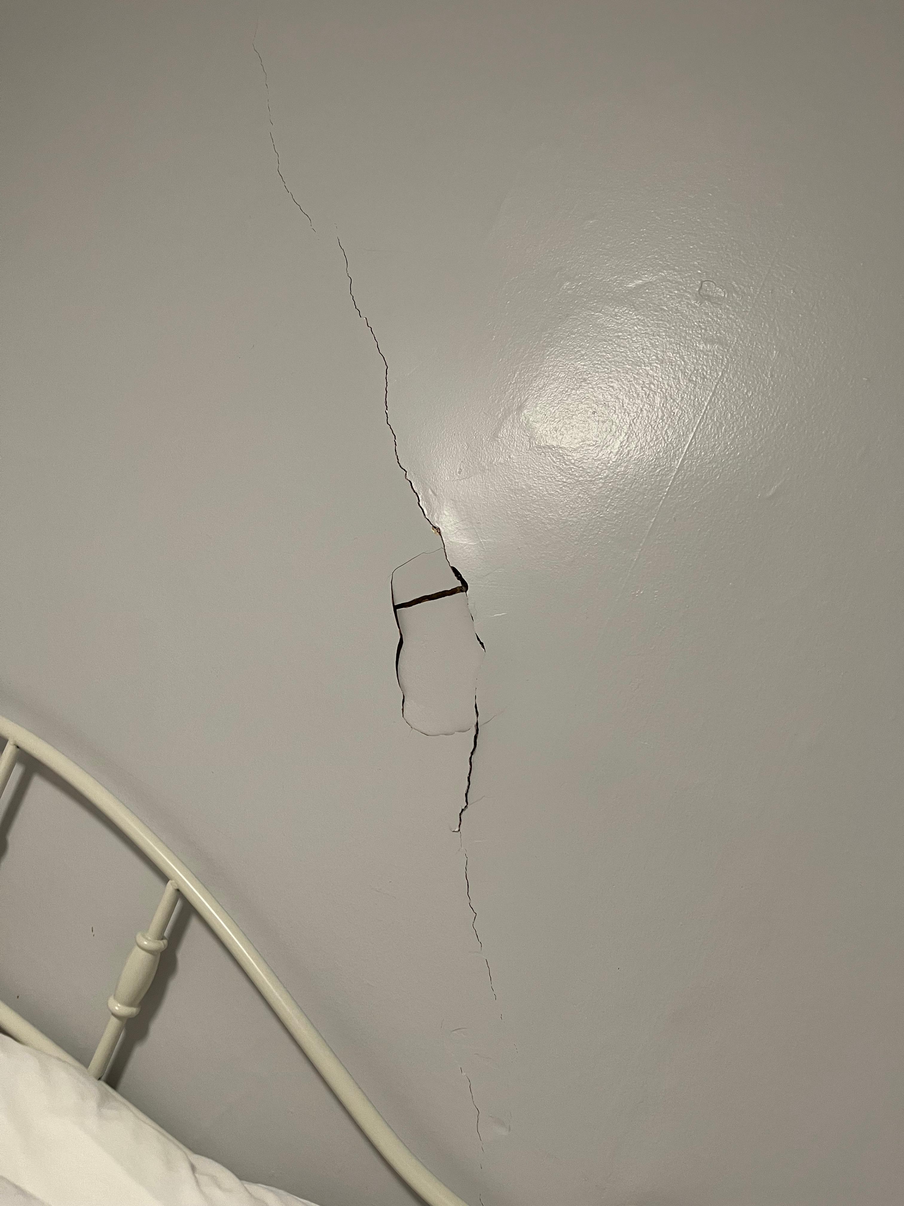 A huge hole in the wall in the master bedroom.