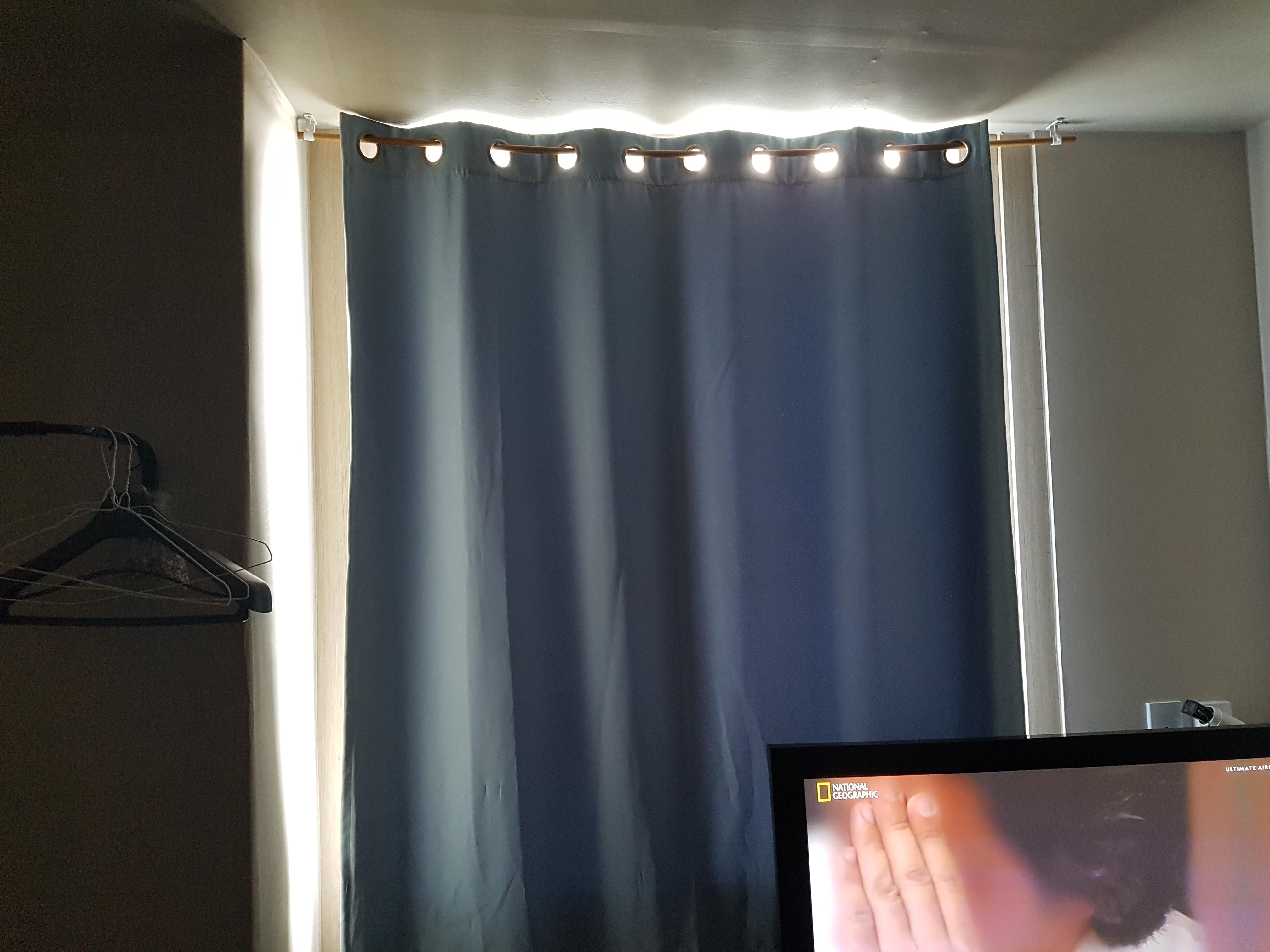 Window curtain barely blocks the light.