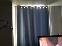 Window curtain barely blocks the light.