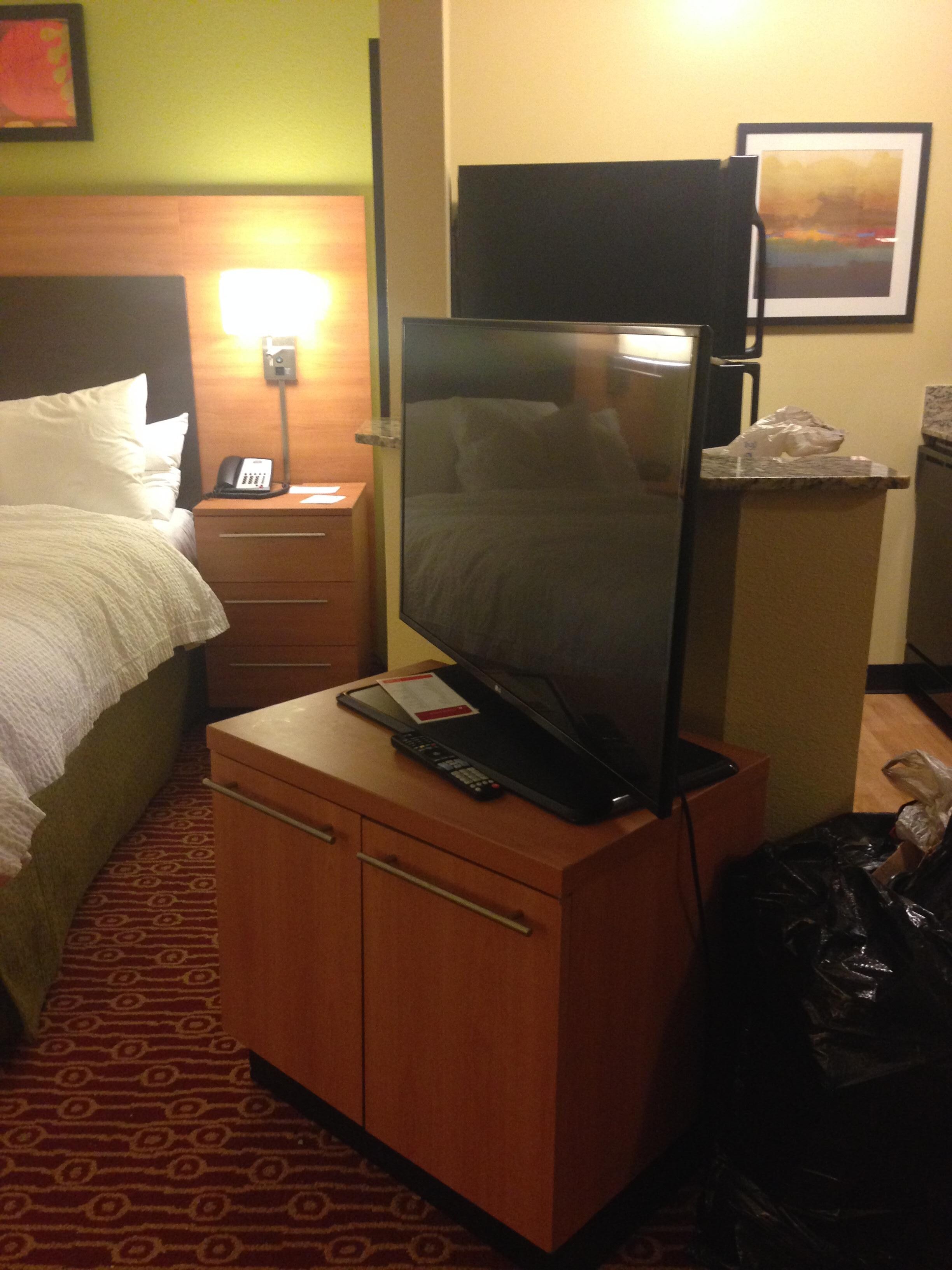 TV at foot of bed facing sofa.