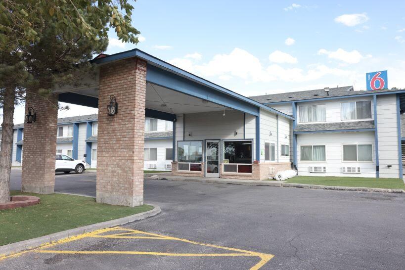 The "6" over the motel, belongs to Motel 6 behind.