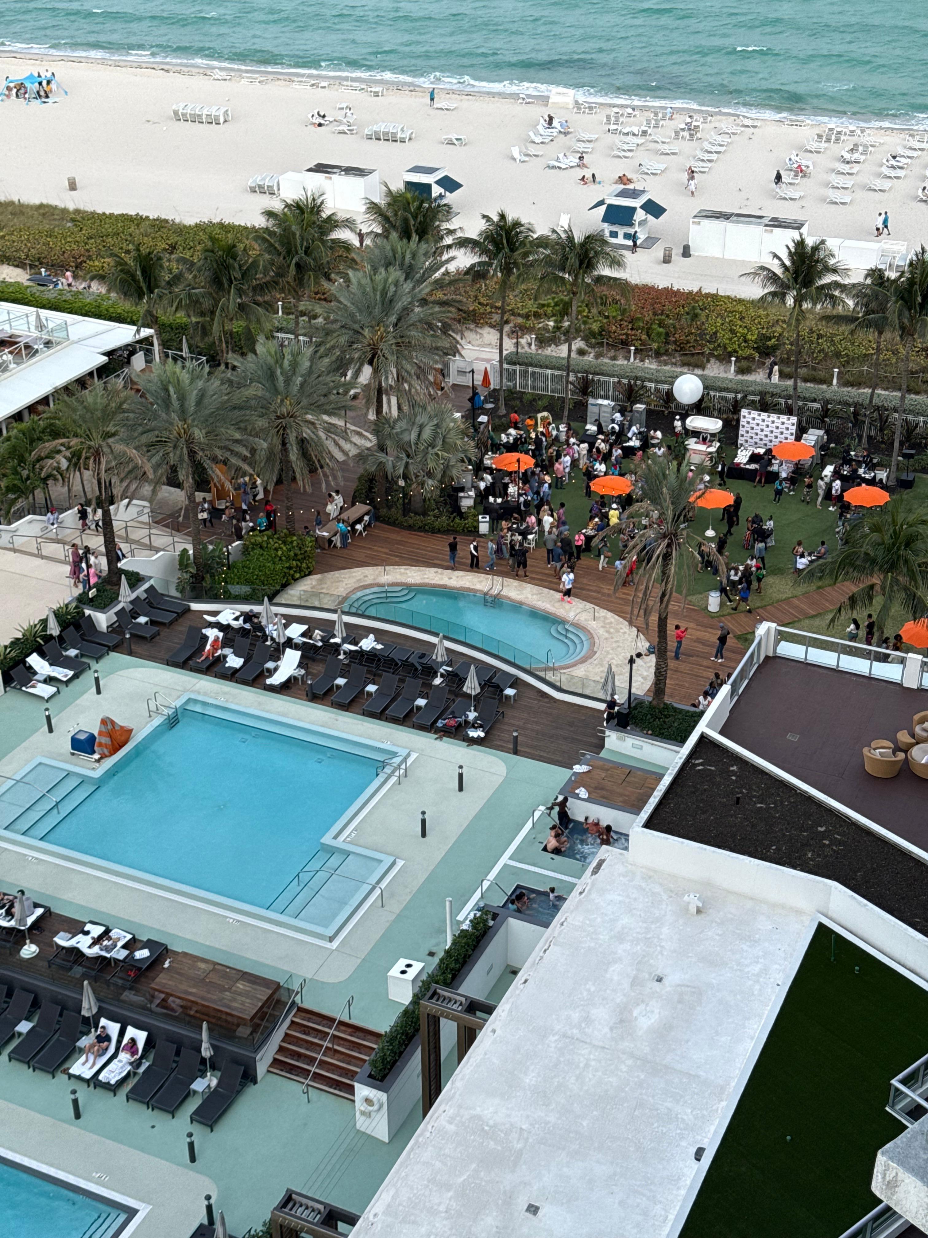 The view of the pools and beach from our room . 