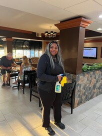 Very friendly staff member cleaning at breakfast.