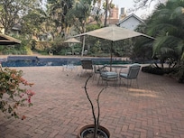 view from the gym out onto the larger pool's patio