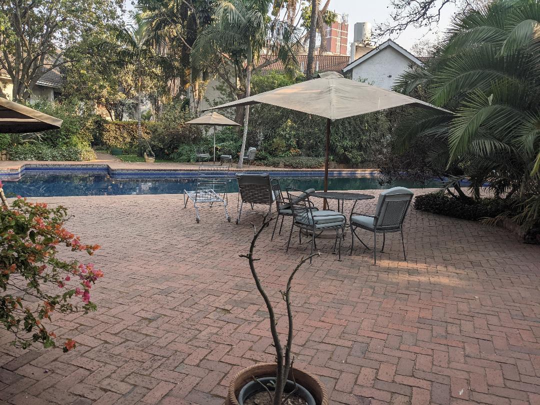 view from the gym out onto the larger pool's patio