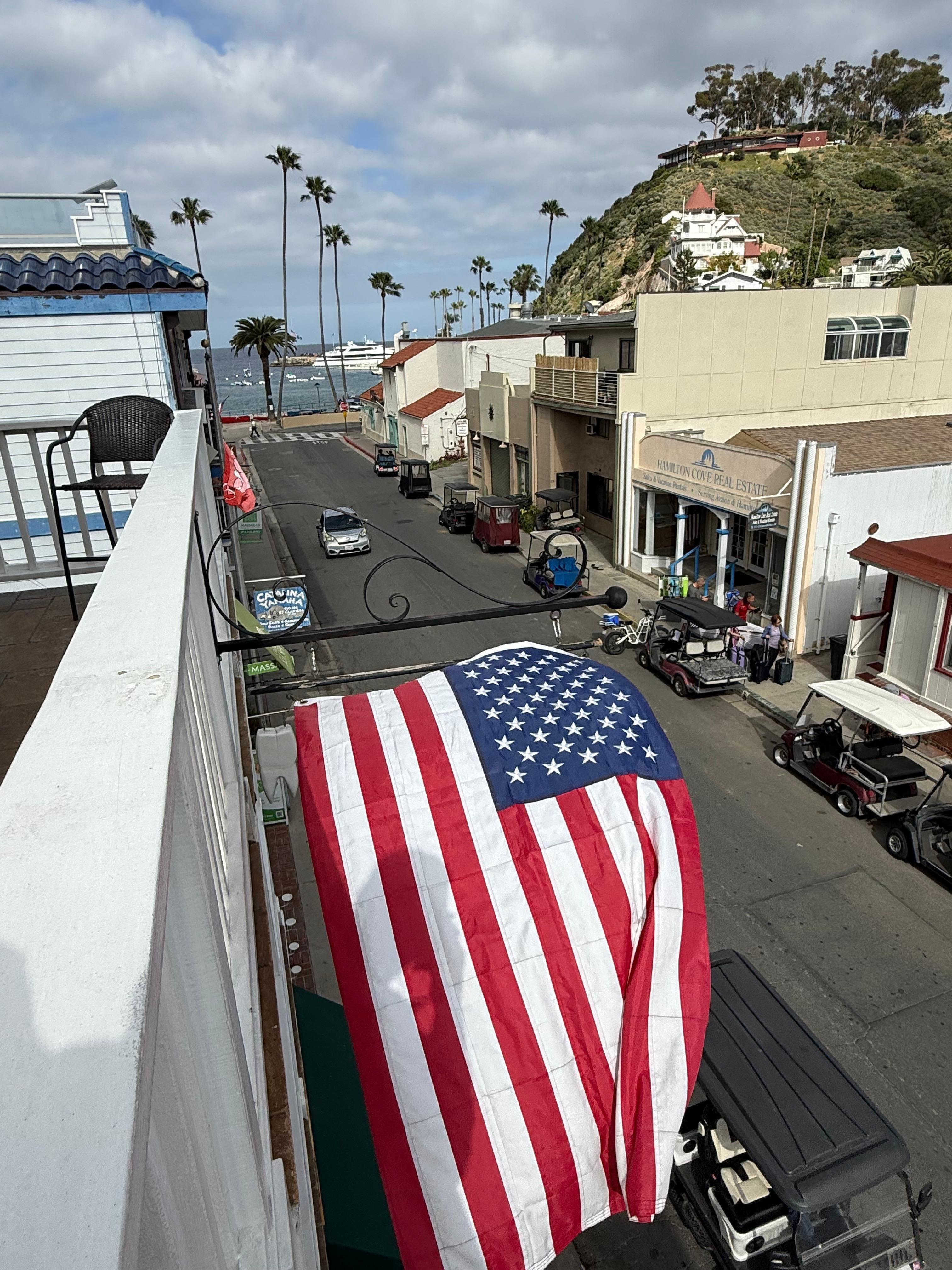 On the second floor balcony overlooking the harbor.