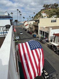On the second floor balcony overlooking the harbor.