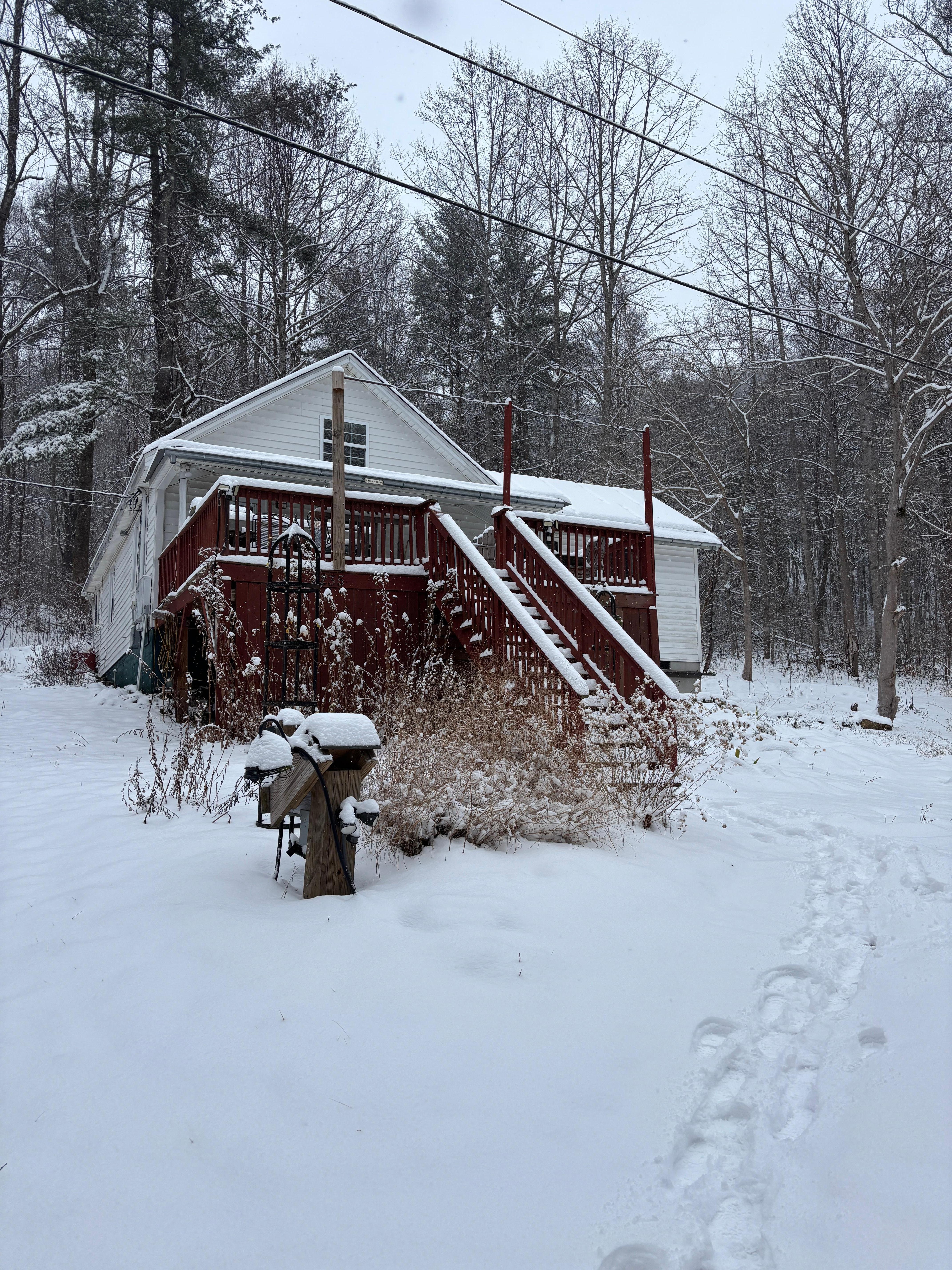 Front of the cabin during some snow.