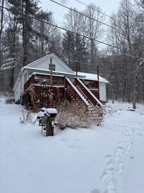 Front of the cabin during some snow.
