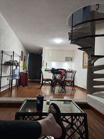 Upstairs has the bathroom, bed area, two closets with robes and phone charger plugs/plug ins behind the pillows for convenient use