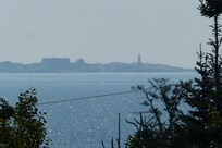 Peggy's Cove Lighthouse in the distance (note that this image was taken with a powerful telephoto lens and it is hard to see with the naked eye)