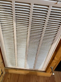 Vent in the living room, covered in black dust