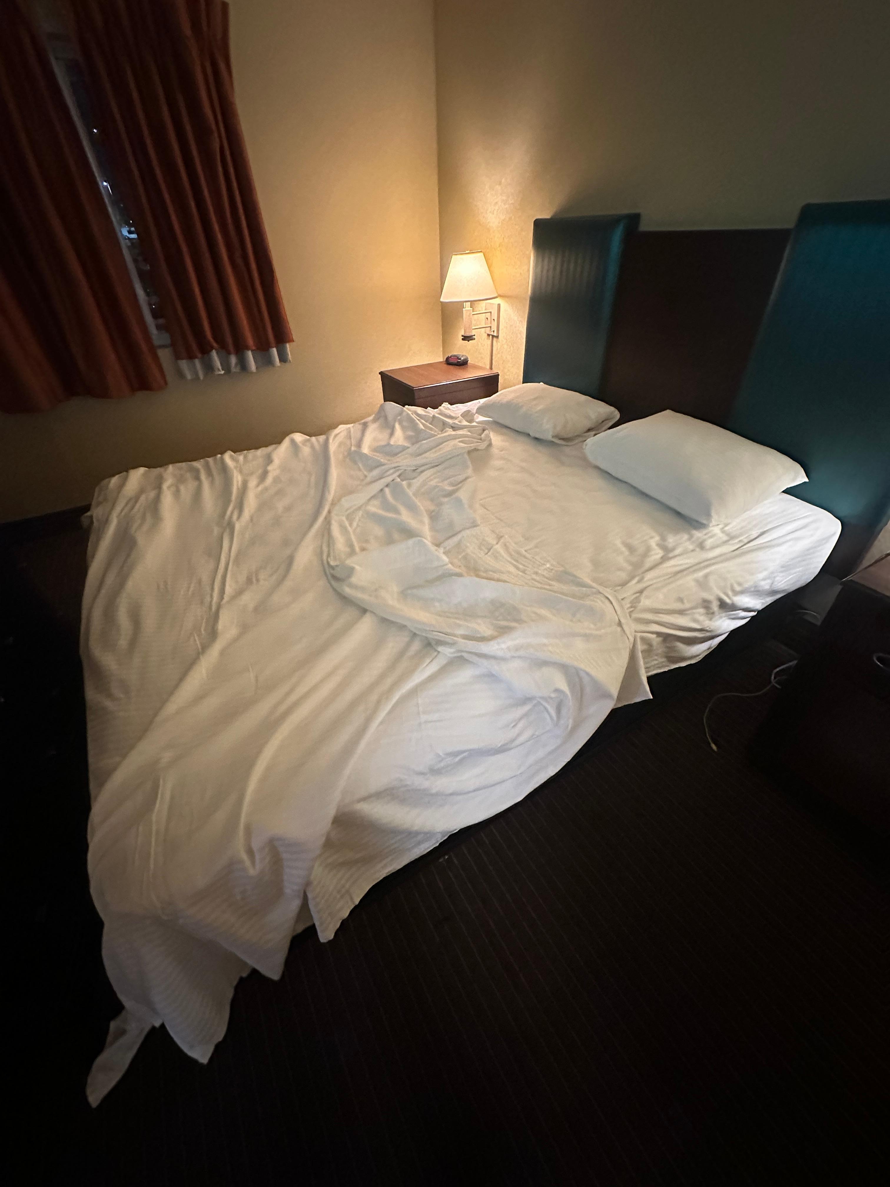 Only one sheet on the bed, goofy pillows, no blanket