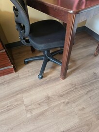The floor is slick, smooth wood looking tile. The chair by the table was nasty filthy, slid out from underneath me causing me to fall. Iwas unable to get up for over 20 minutes, and my right knee is still not healed, I am still using a cane.