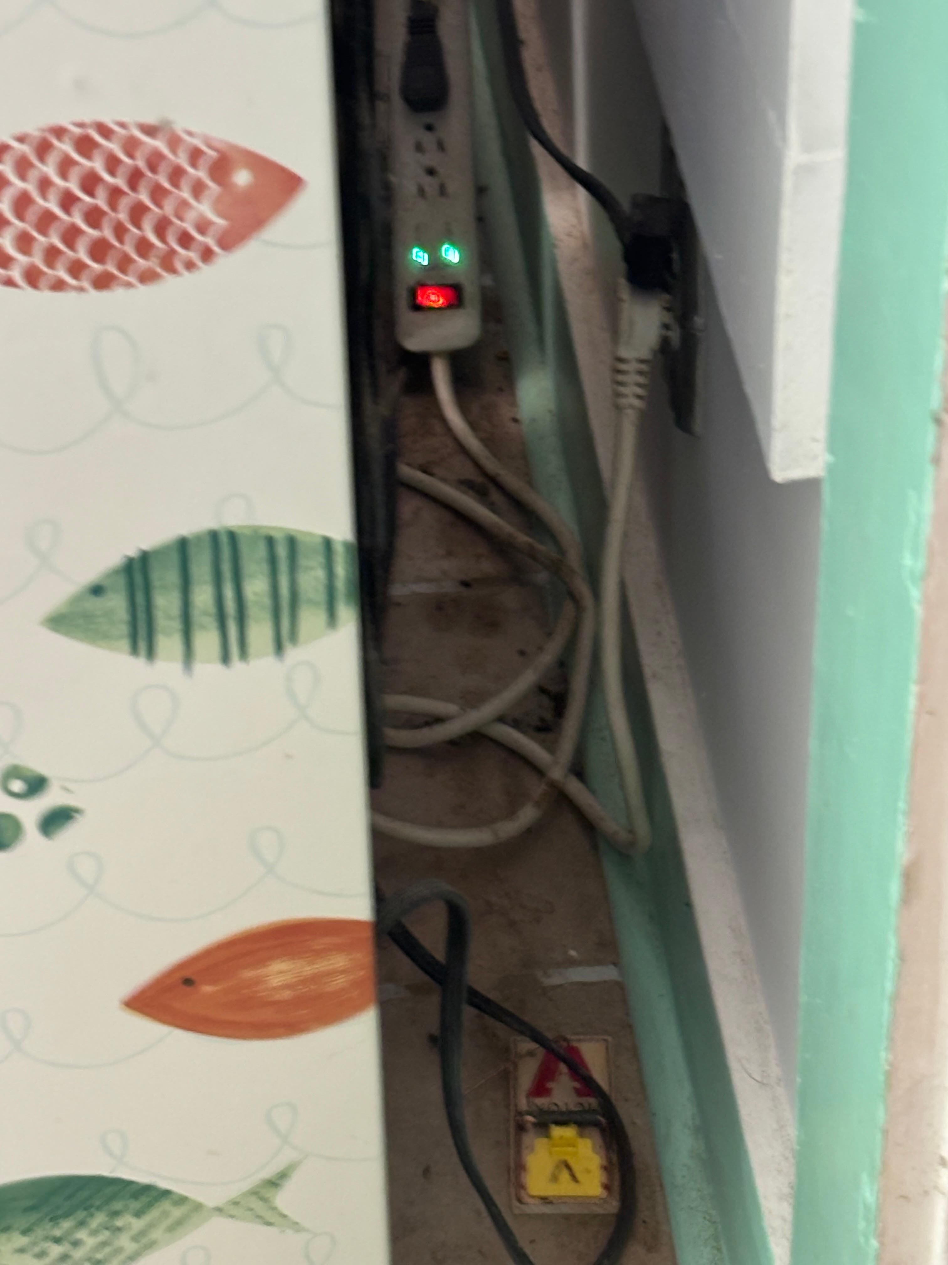 Floor in the kitchen behind the fridge. Dirty and has mouse droppings. This area is easily accessible since it is right by the doorway. A child could easily reach the mouse trap. 